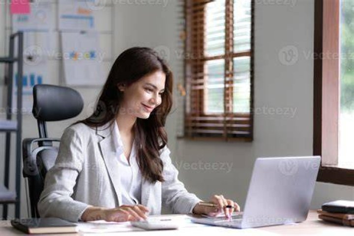 Woman working on her laptop in a cafe