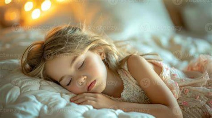 young girl sleeping with her dog