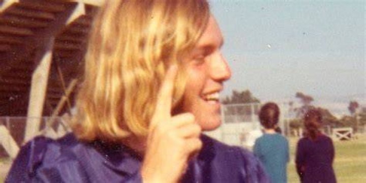 Young Greg Laurie smiling and looking sideways